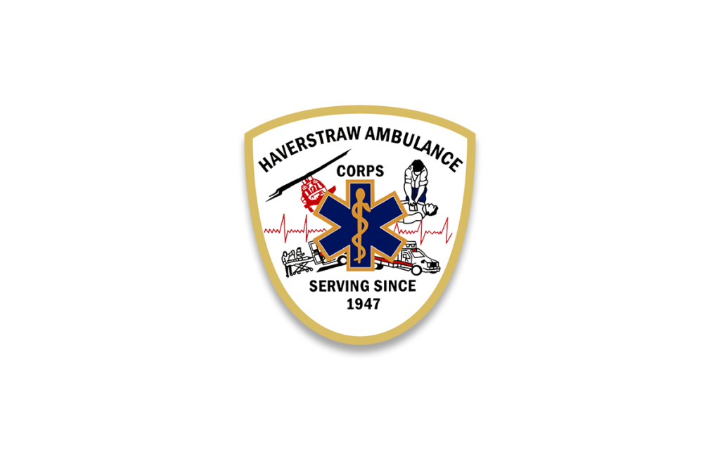 Logo of Haverstraw Ambulance Corps featuring a white shield with a beige border. In the center is a blue star of life with a snake and staff, surrounded by illustrations of an ambulance, heartbeat line, and a helicopter. Text reads "Haverstraw Ambulance Corps Serving Since 1947.